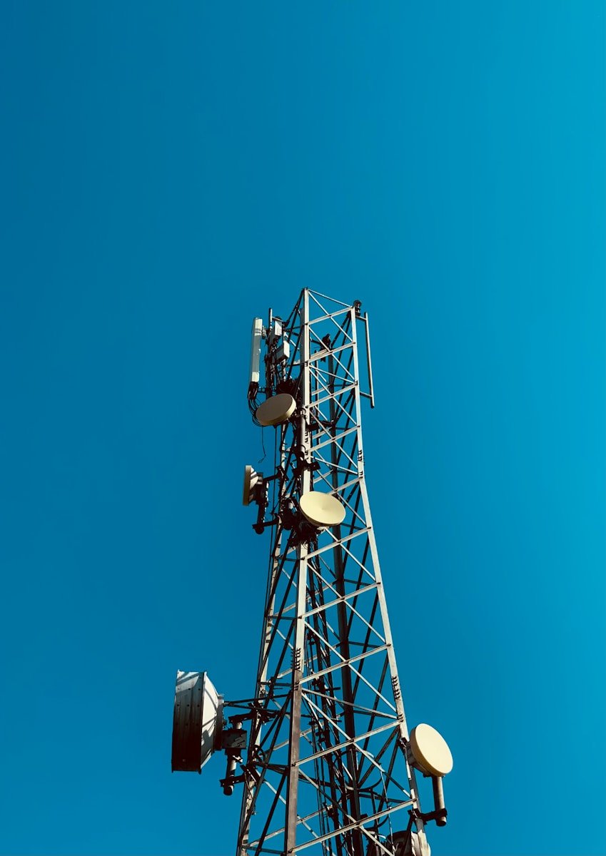 a cell phone tower with a blue sky in the background